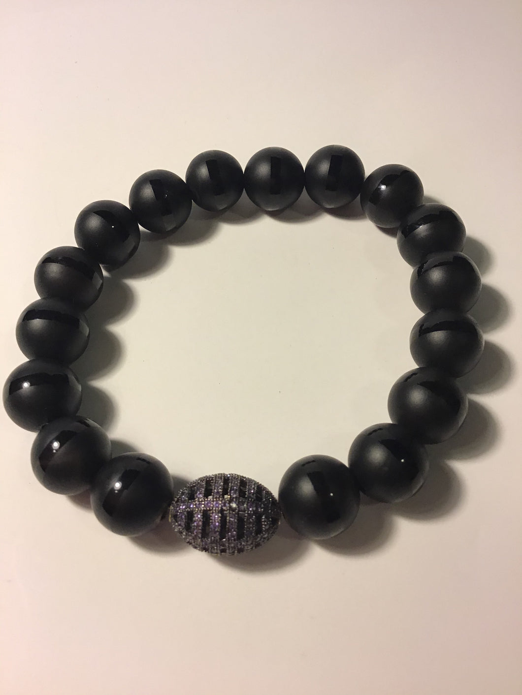 Black Matte onyx with purple sparkly charm.