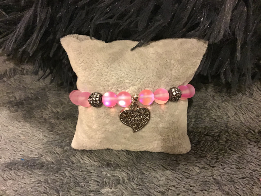 Pink bracelet with silver accents and heart charm